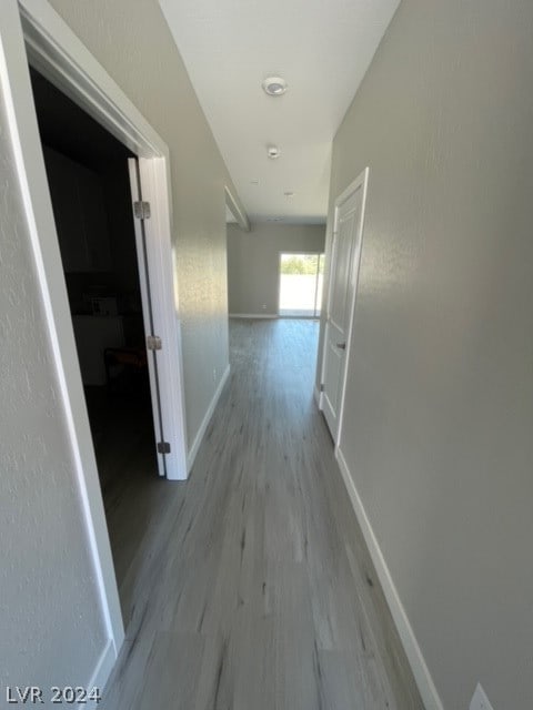 corridor with wood-type flooring