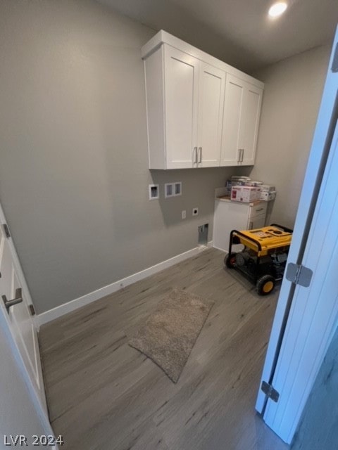 clothes washing area with hookup for a washing machine, cabinets, hardwood / wood-style floors, and electric dryer hookup