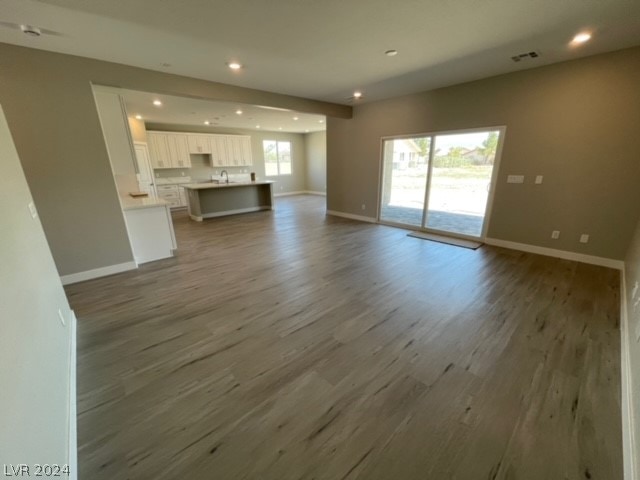 unfurnished living room with hardwood / wood-style flooring