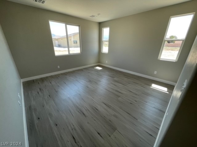 spare room featuring dark hardwood / wood-style floors