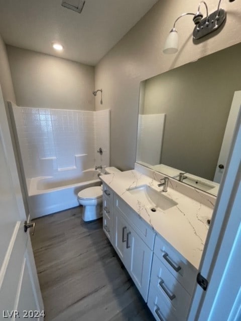 full bathroom featuring shower / tub combination, vanity, wood-type flooring, and toilet