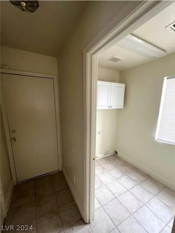 hallway featuring light tile patterned floors