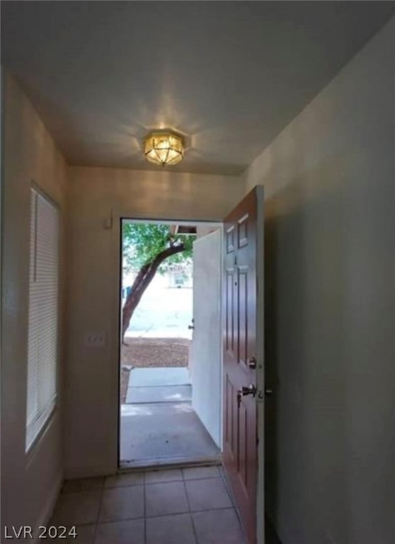 doorway to outside featuring tile floors