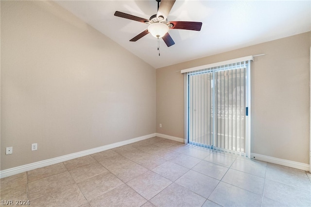 empty room with lofted ceiling, light tile patterned floors, and ceiling fan