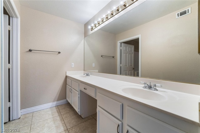 bathroom with tile patterned flooring and dual bowl vanity