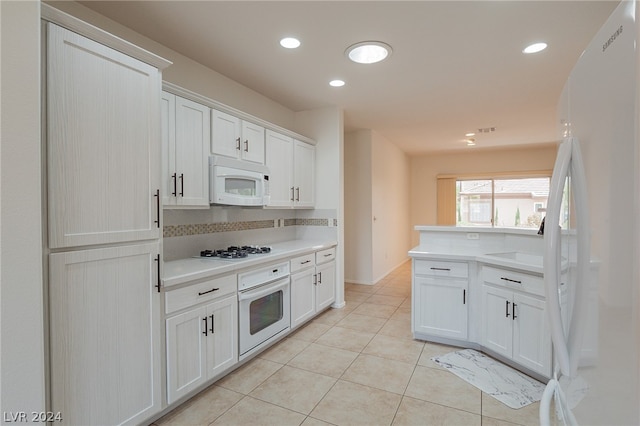 kitchen with backsplash, white cabinetry, light tile patterned floors, and white appliances