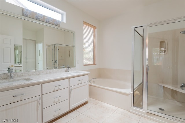 bathroom featuring vanity, tile patterned flooring, and plus walk in shower