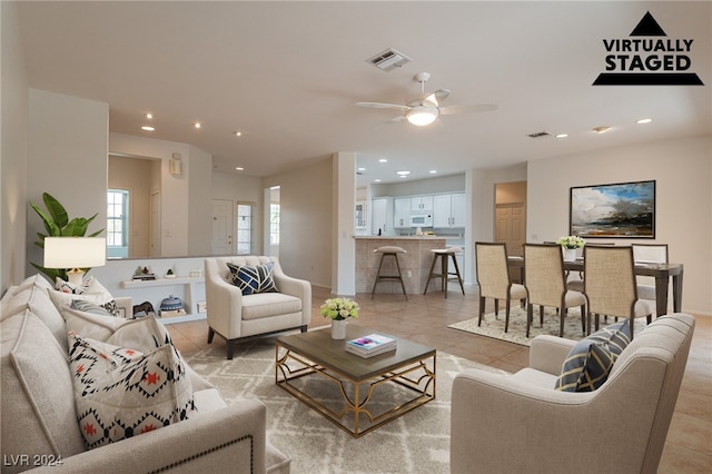 tiled living room with ceiling fan