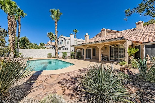 view of pool with a patio and ceiling fan