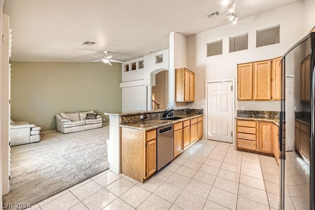 kitchen with sink, ceiling fan, stainless steel dishwasher, light colored carpet, and kitchen peninsula