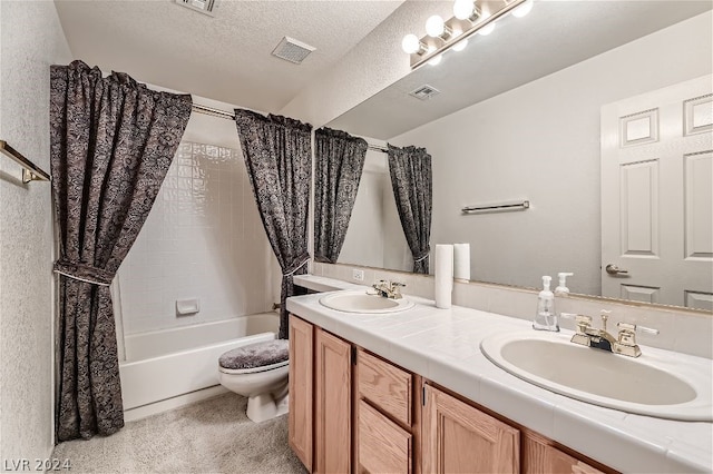 full bathroom featuring shower / tub combo with curtain, vanity, toilet, and a textured ceiling