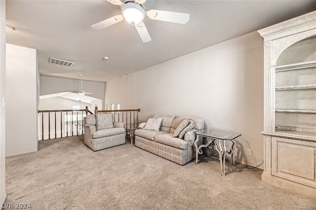 living room featuring ceiling fan, light colored carpet, and vaulted ceiling