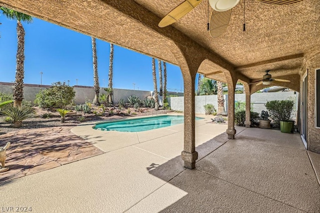 view of swimming pool featuring ceiling fan and a patio area