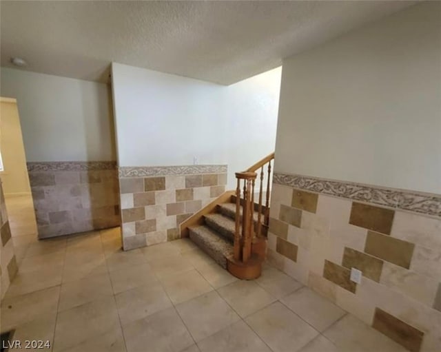 stairway with light tile floors