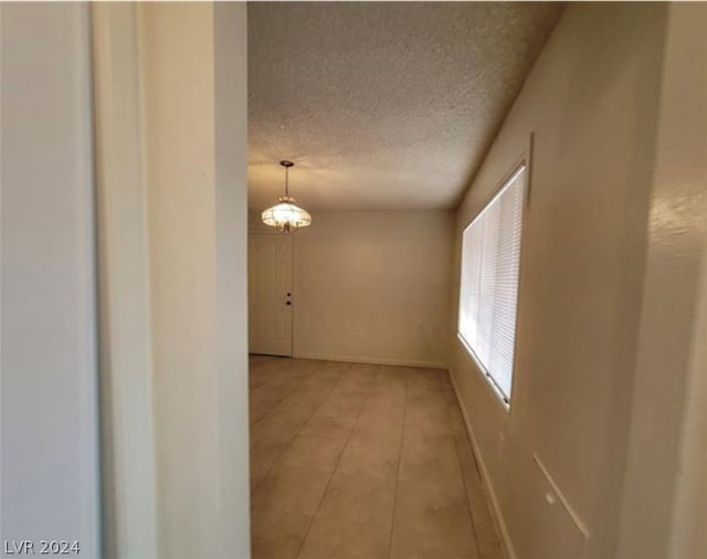 interior space featuring tile flooring and a textured ceiling