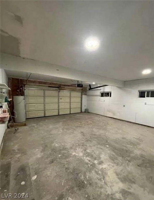 garage featuring a garage door opener and water heater