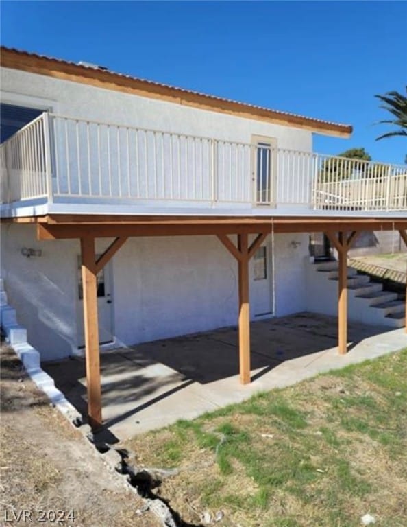 rear view of house with a wooden deck