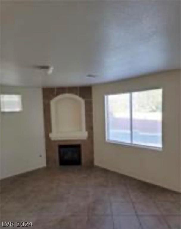 unfurnished living room featuring a fireplace