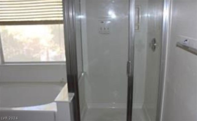 bathroom featuring shower with separate bathtub