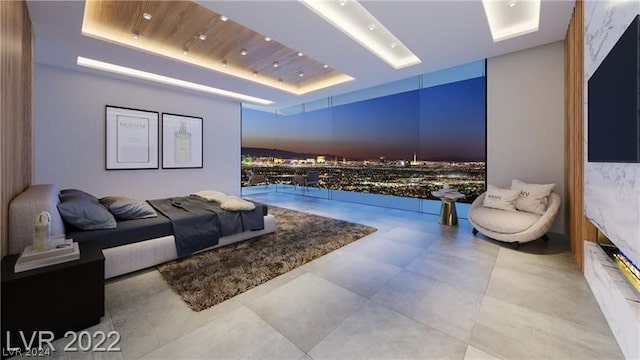 tiled living room featuring a raised ceiling