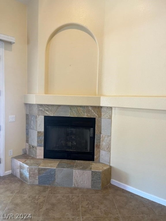 details featuring tile flooring and a tile fireplace