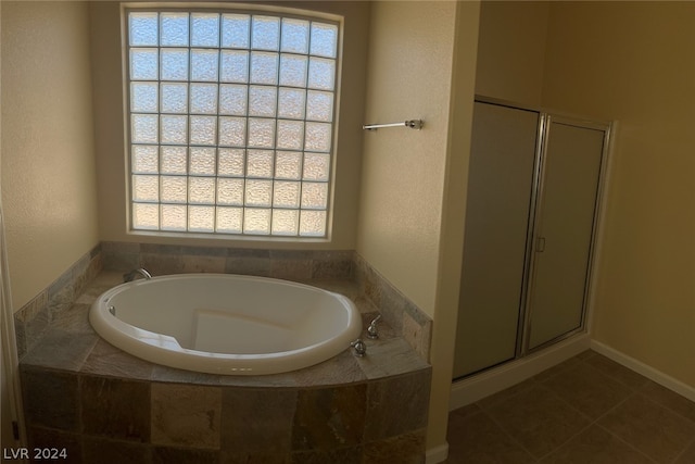 bathroom with tile floors and independent shower and bath