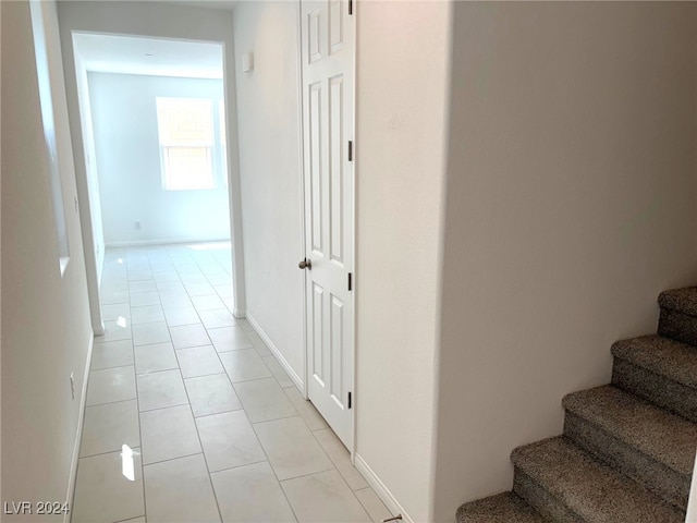 hall with light tile patterned floors