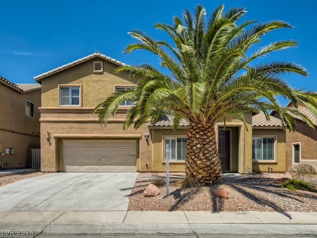 mediterranean / spanish-style home with a garage