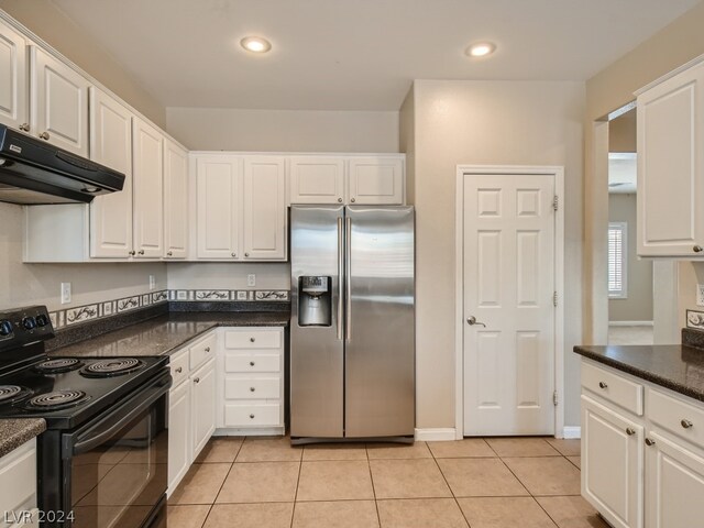 kitchen featuring white cabinets, electric range, stainless steel fridge, and light tile floors