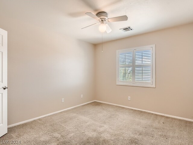 spare room with carpet flooring and ceiling fan