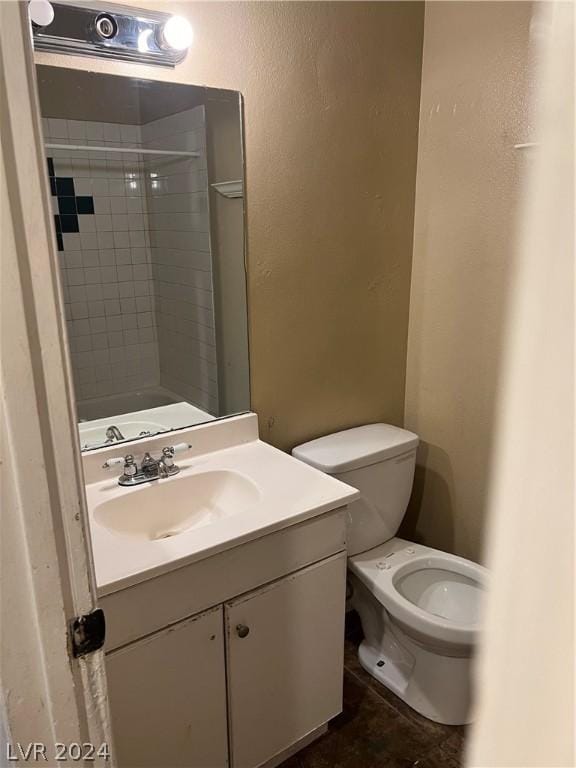 full bath with a shower, vanity, and toilet