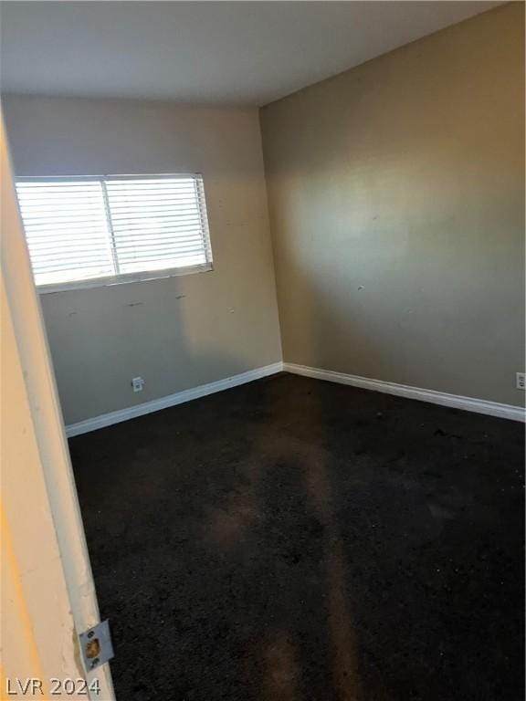 empty room featuring baseboards