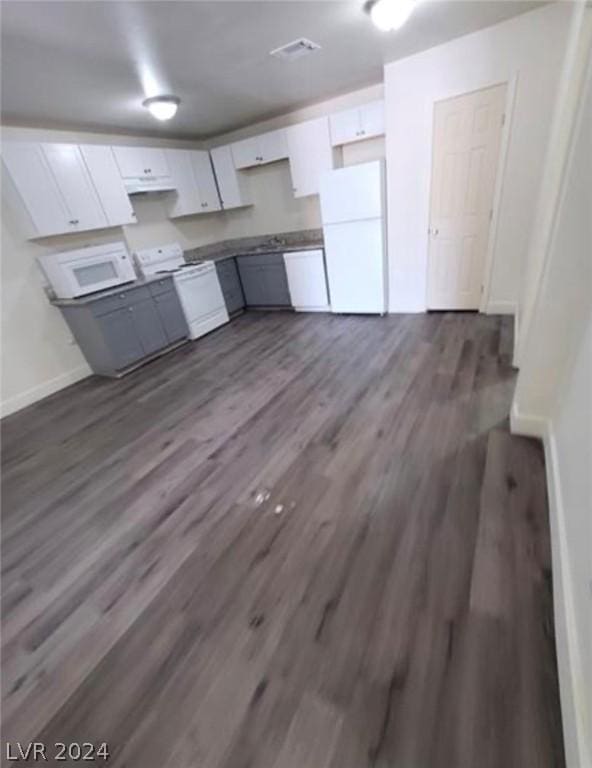 kitchen featuring white cabinetry, white appliances, and dark hardwood / wood-style floors