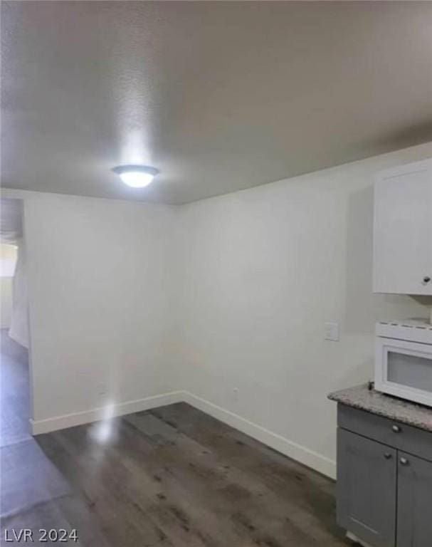 unfurnished dining area featuring dark hardwood / wood-style flooring