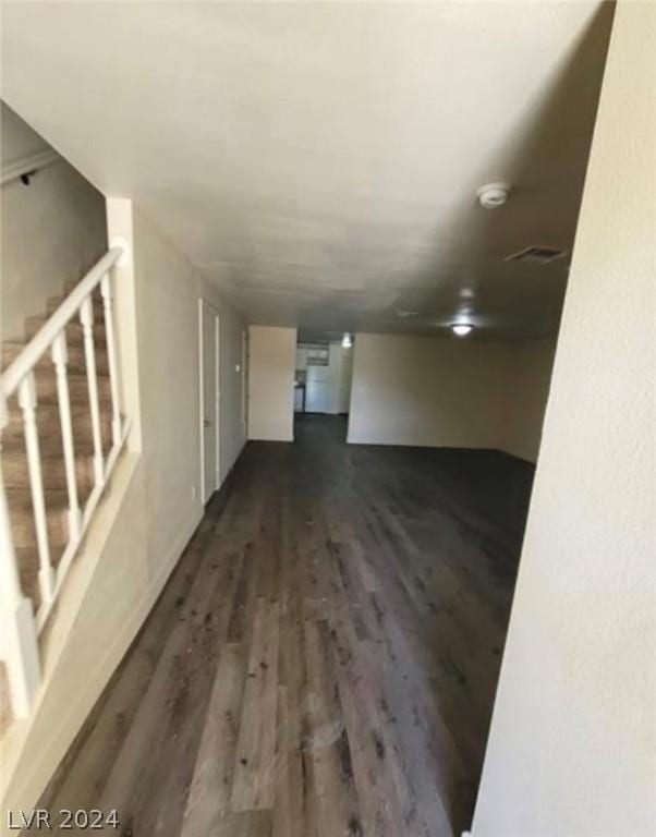 spare room with dark wood-type flooring