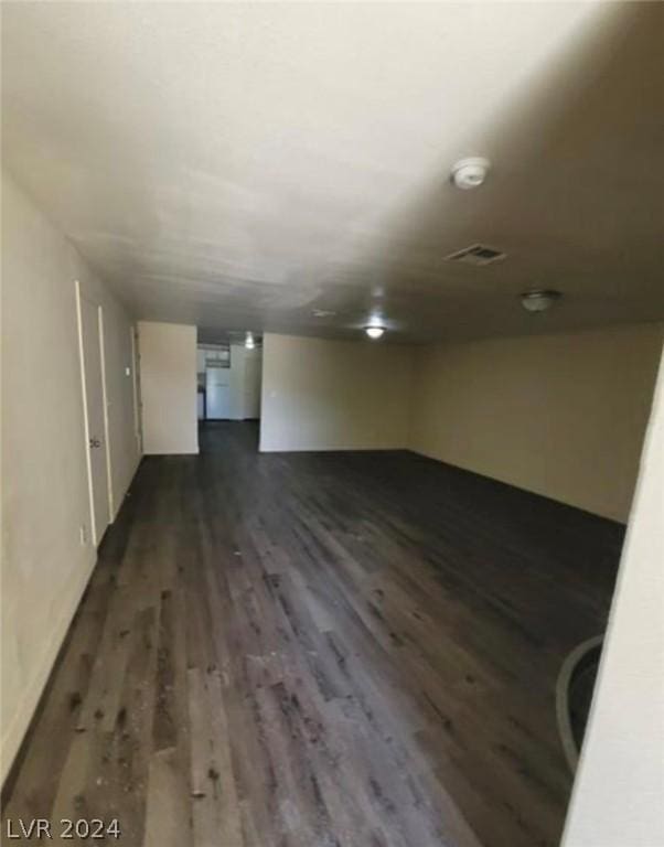 empty room with dark hardwood / wood-style flooring