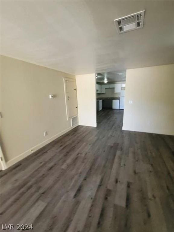 unfurnished living room featuring dark wood-type flooring