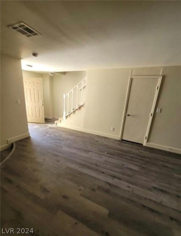 unfurnished room with dark hardwood / wood-style flooring