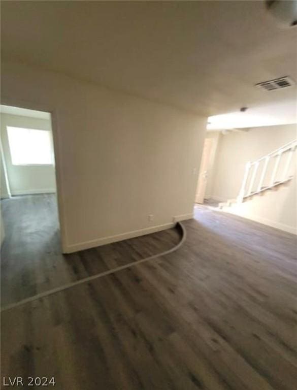 spare room with dark hardwood / wood-style floors