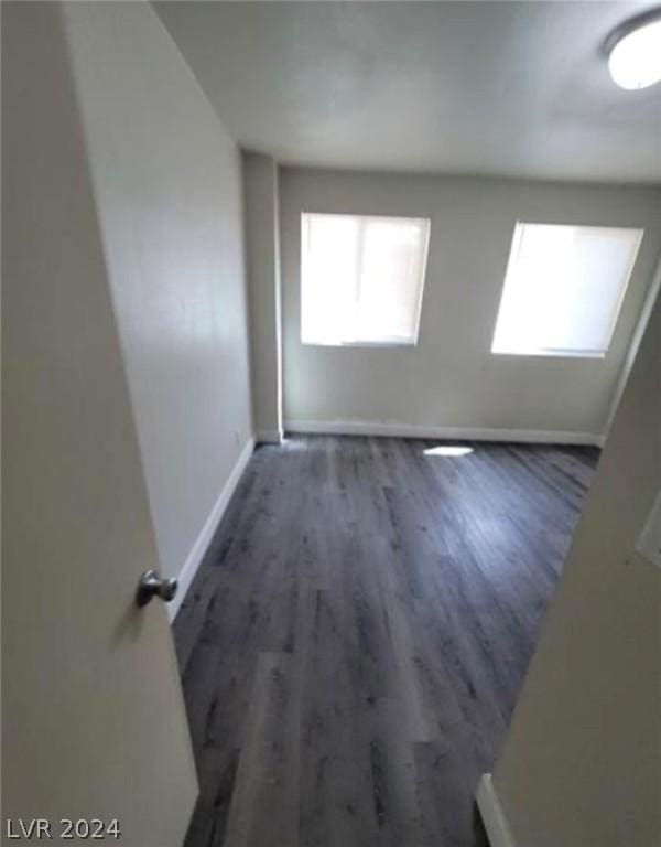 empty room with dark wood-type flooring