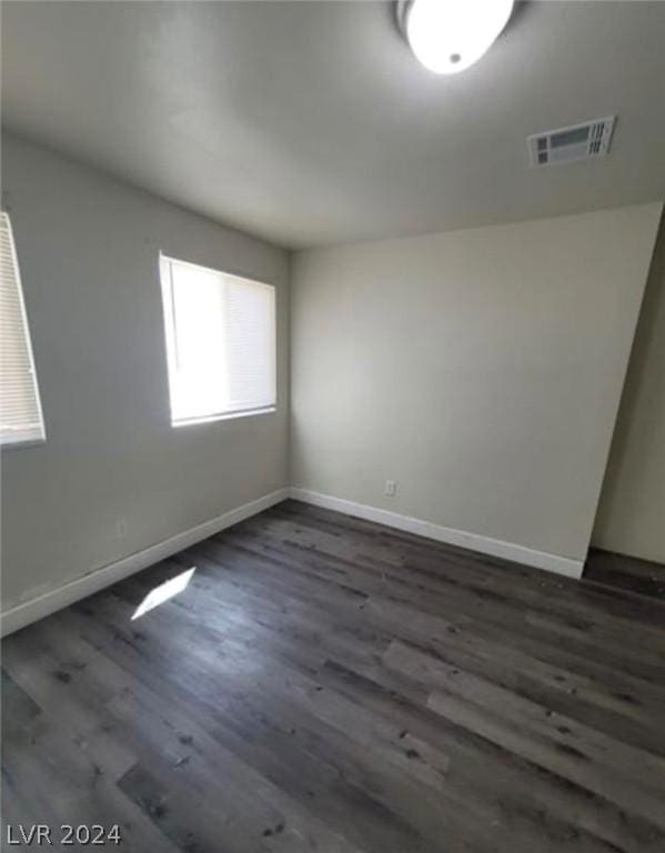 spare room featuring dark hardwood / wood-style flooring