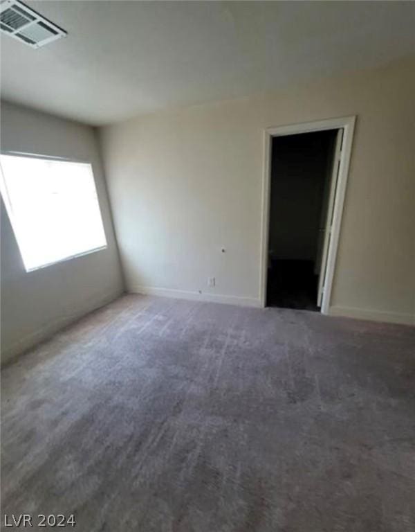 empty room featuring dark colored carpet