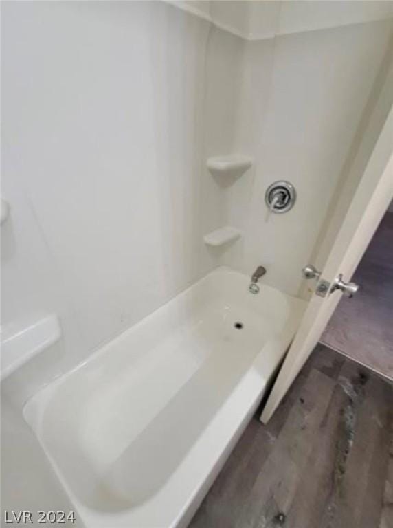 bathroom featuring hardwood / wood-style flooring and shower / tub combination