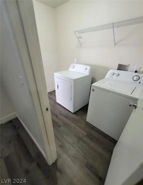 laundry room with separate washer and dryer and dark wood-type flooring