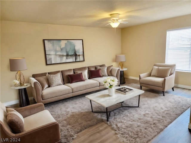 living room with ceiling fan and light hardwood / wood-style flooring