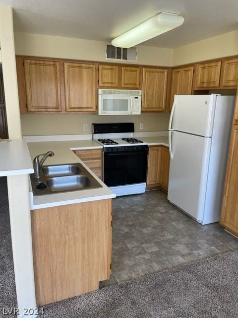 kitchen featuring sink, dark tile patterned flooring, kitchen peninsula, and white appliances