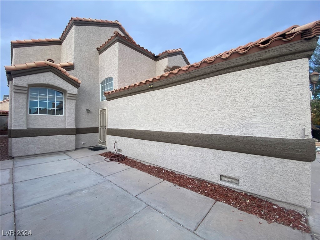 view of property exterior featuring a patio area