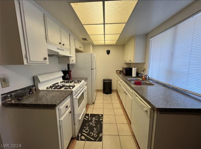 kitchen with white cabinetry, white appliances, sink, and light tile patterned floors