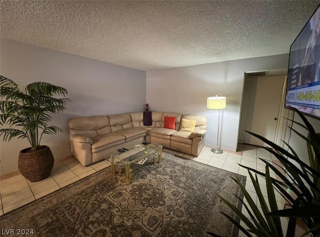 living room featuring light tile patterned floors and a textured ceiling