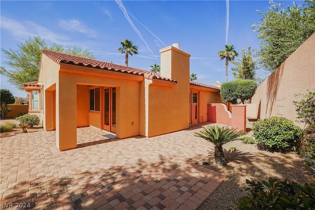 rear view of property featuring a patio area